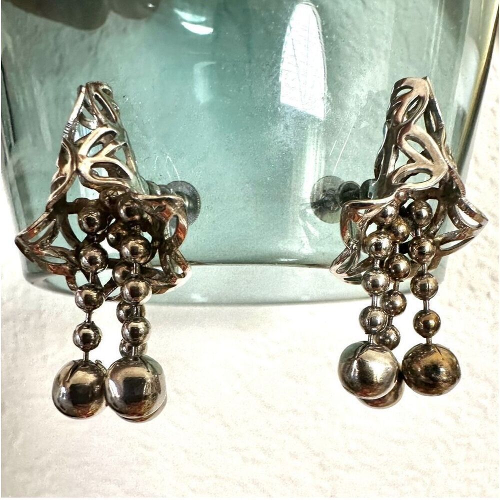 Silver tone dangle clip on earrings